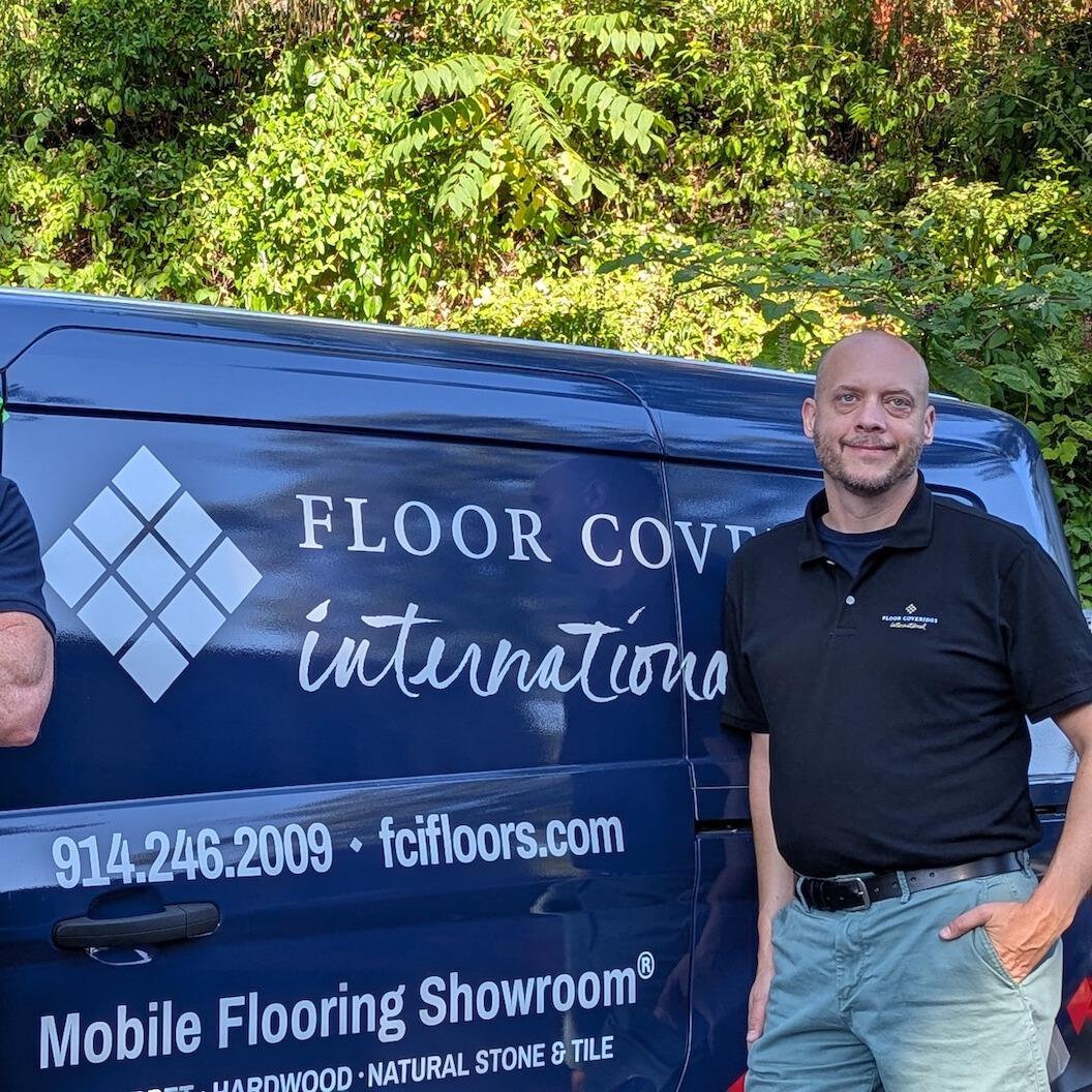 Two men in FCI polos standing in front of a Mobile Showroom