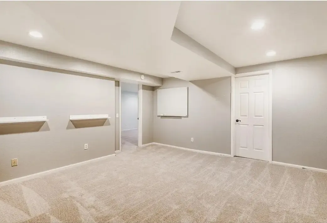 A clean, empty room featuring light carpeting and white walls, showcasing fresh flooring in Aurora, CO.