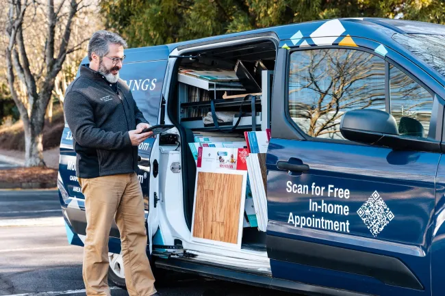 Man in front of mobile showroom