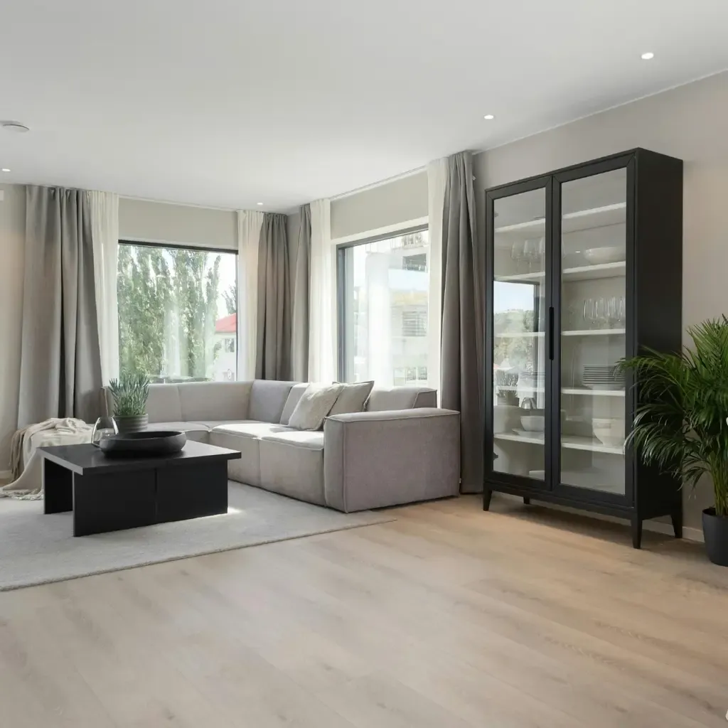 Stylish living room with a cozy couch, minimalist coffee table, and a window that enhances the space with sunlight.