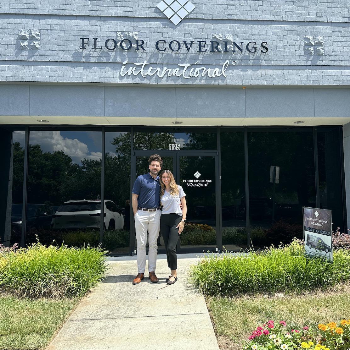 two people in front of Floor Coverings International storefront