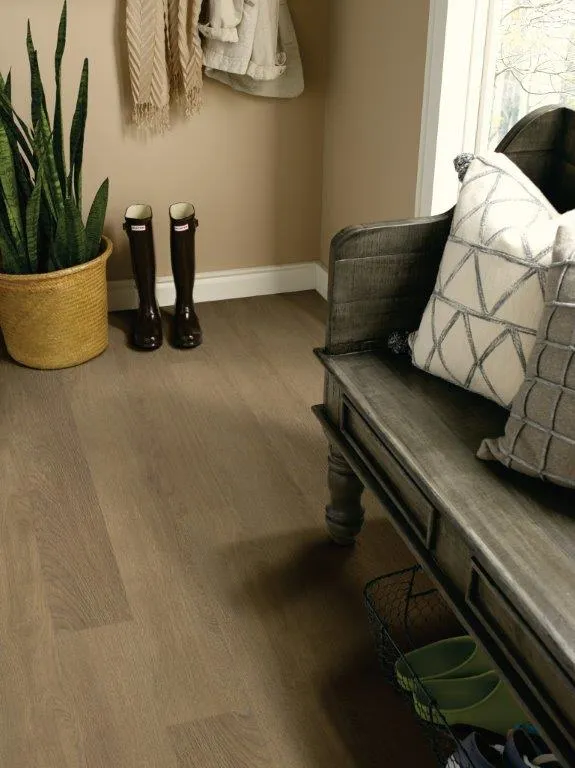 Entryway with a bench, rubber boots and a potted plant on beautiful engineered hardwood flooring