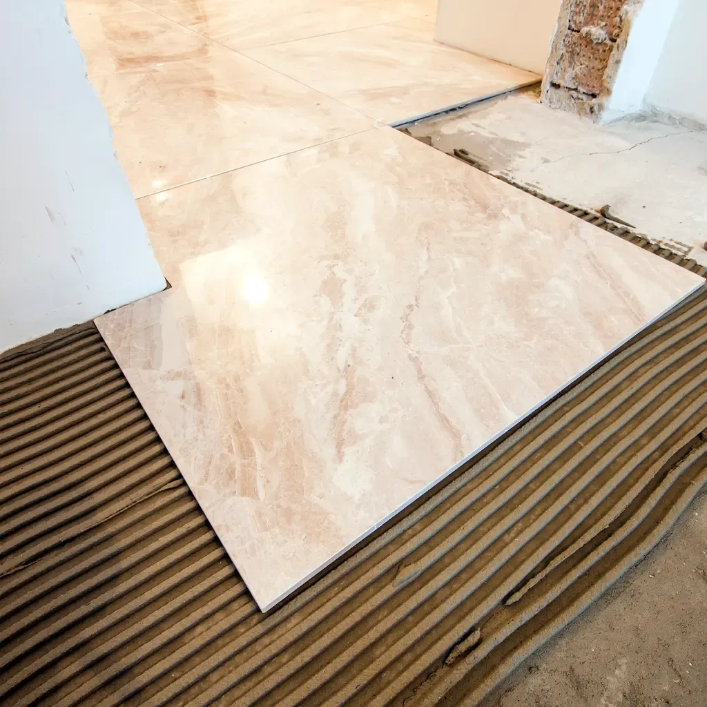 Installation of a marble floor in a room by Custom Tile, located in Jupiter, FL, highlighting craftsmanship and design.