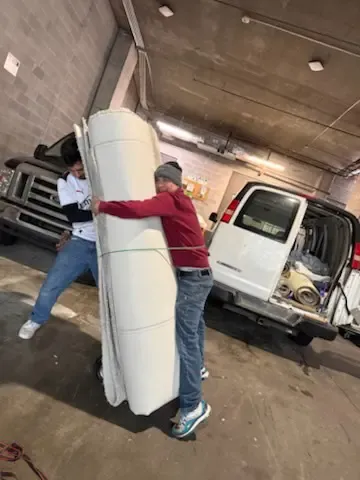 Man picking up carpet for job