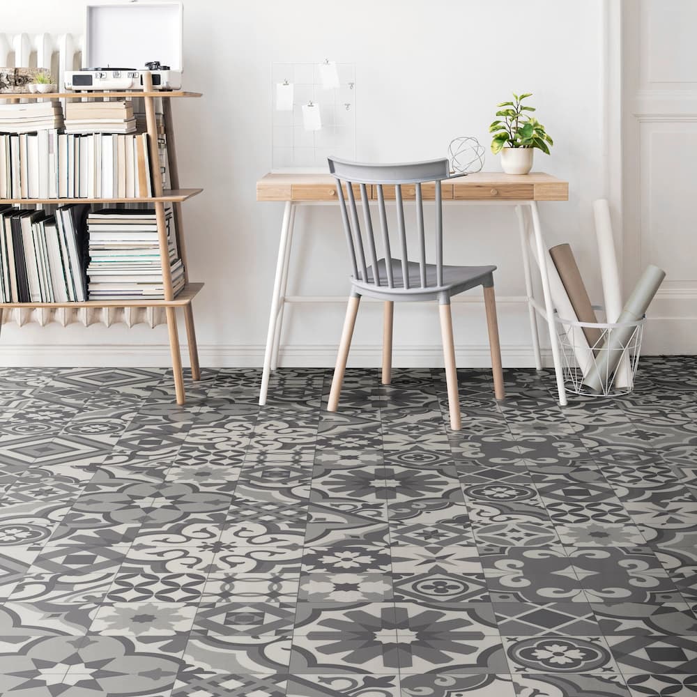 Eclectic mosaic tile flooring in a room with a bookshelf and study table